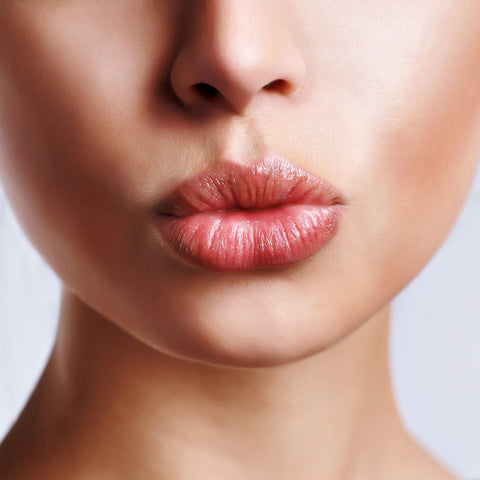 woman doing a kissy face with her non dry lips