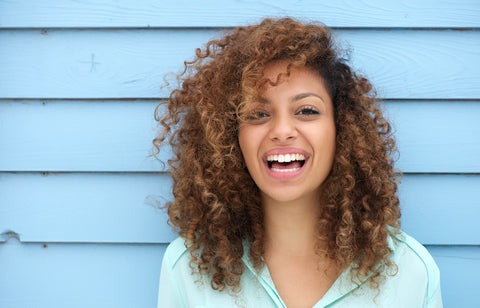 Smiling woman wearing Lip Tint Conditioner