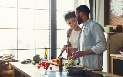 Couple making a salad with coconut oil 