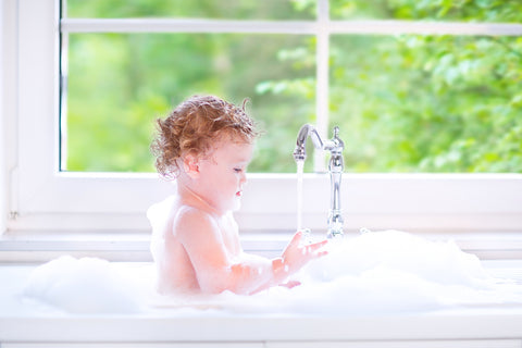 baby taking bath to prevent dry skin