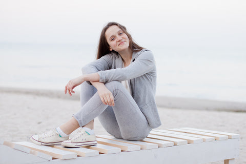 Woman sitting on a bench at the beach