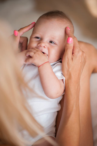 Mom soothing baby with irritated skin