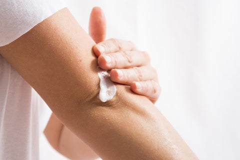 Person applying Miracle Cream on elbow