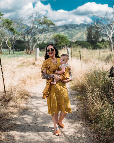 Mom holding baby while on a walk