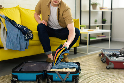 Woman using her packing list for vacation to prepare for a trip