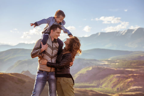 Family on a hike with child on dads shoulder