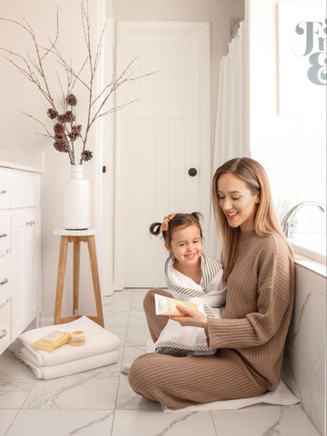 Mom drying child off after shower to calm her during her terrible twos 