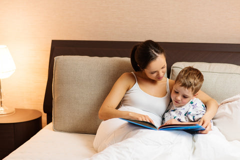 Mom reading during toddler bedtime routine 