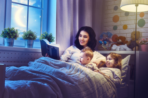 Mom reading to kids as a part of toddler bedtime routine