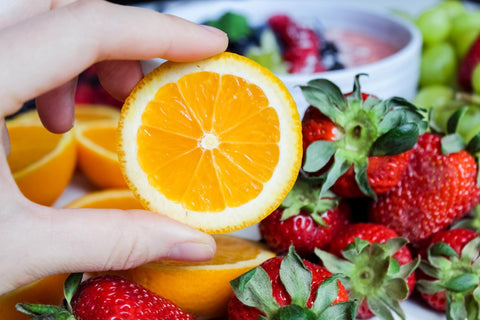 Oranges and strawberries contain vitamin c that help with uneven skin tone