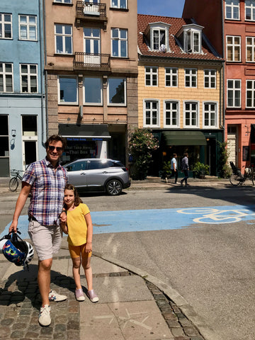 family photo in Copenhagen Denmark cargo bike passes behind in bike lane