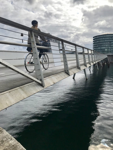 a woman cyclist crosses a cycling and pedestrian bridge only for walking and biking in Copenhagen Denmark