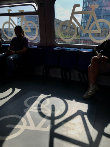 shadows and bicycles painted inside a bike train copenhagen denmark