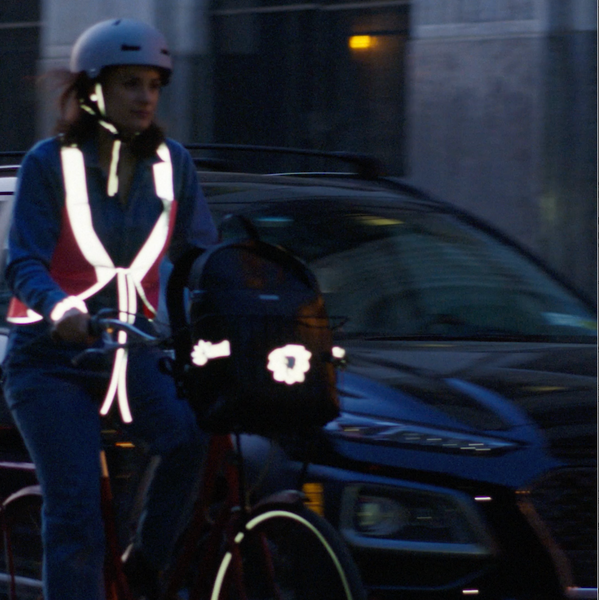 sarah canner in vespertine nyc refletive vest riding bicycle in brooklyn ny