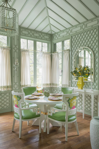 A dining room filled with elegant dining room furniture and a large window.
