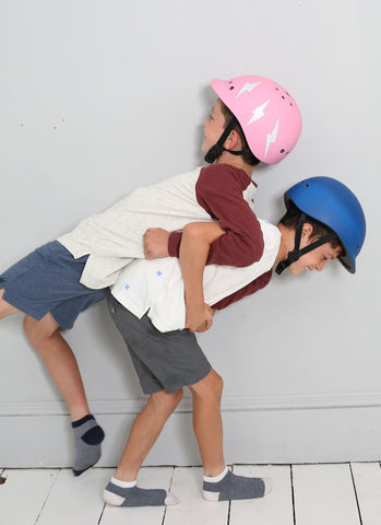 Boys playing with kid helmets on 