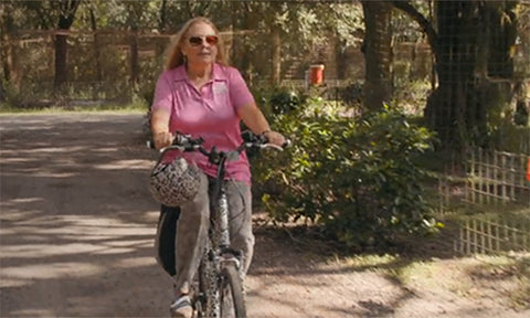 Carole Baskin cycling through her sanctuary with a Sawako Helmet 