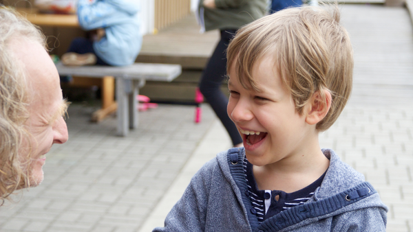 Happy child smiling at his grandfather