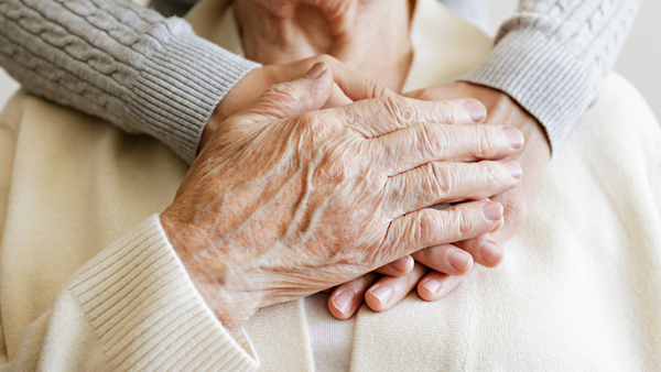 Clasped hands of elderly people. What about probiotics for Parkinson's?