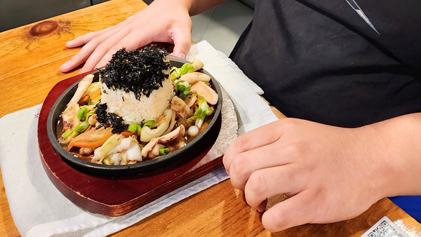 Isaiah's meal at Sarang Kitchen - stir-fried squid with a seaweed-covered rice bom