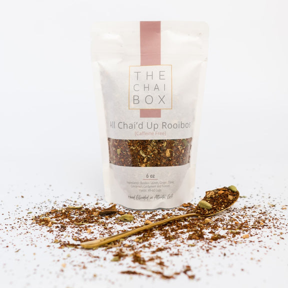 The Chai Box All Chai'd Up Rooibos Caffeine Free Loose Leaf Tea Blend bag with spoon. All Chai'd Up Rooibos is an infusion of Western and Eastern flavors.