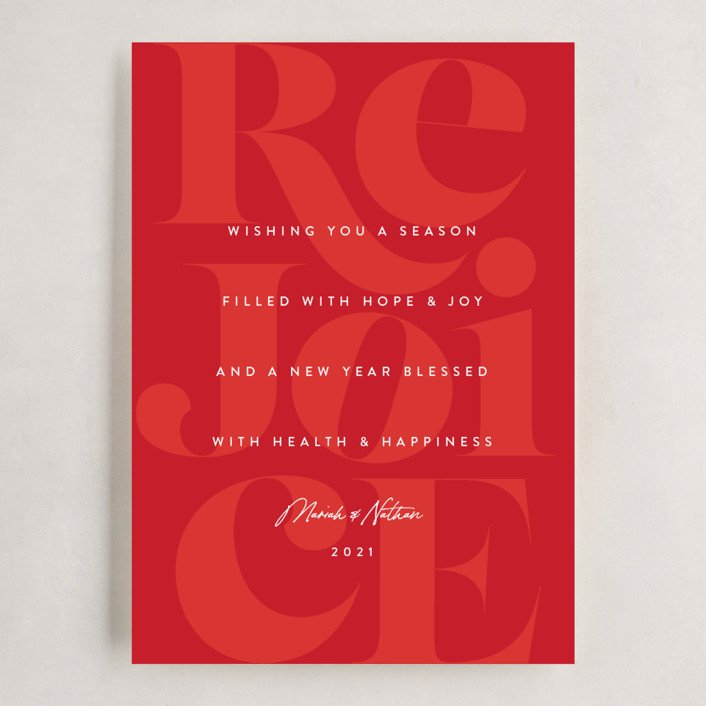 Holiday card in red with the letters REJOICE in silhouette