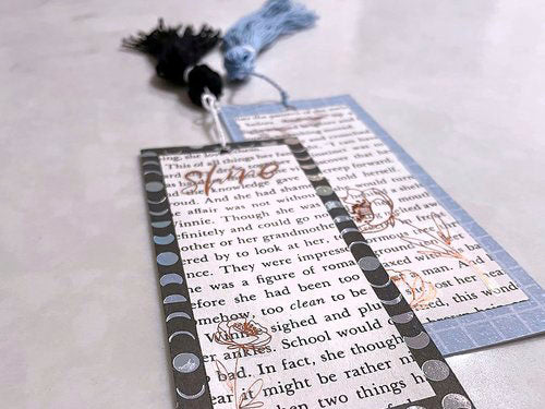 image of two handmade bookmarks with text, layers, patterns, and tassels