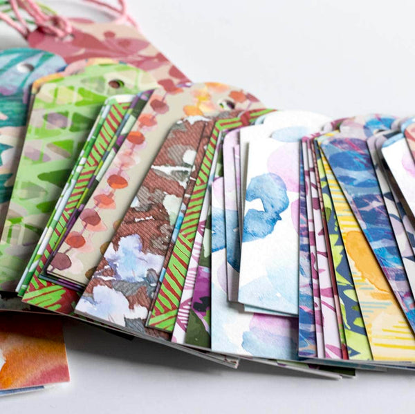 Pile of hand painted and printed gift tags featuring patterns by jenny bova