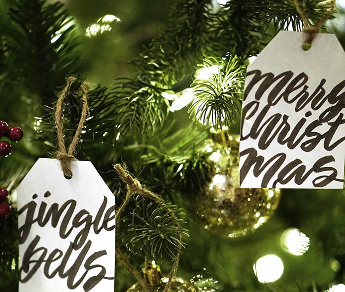 Image of gift tags with calligraphy used as Christmas tree ornaments