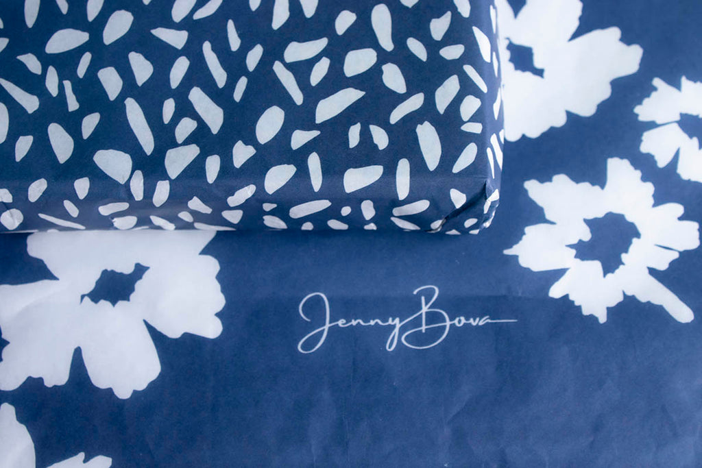 custom tissue paper in deep blue with jenny bova logo and abstract designs