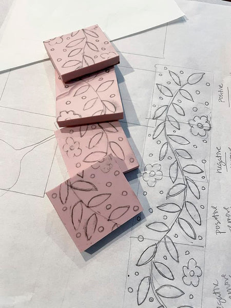 image of carved stamping blocks with sketch on trace paper. design is leaves and flowers
