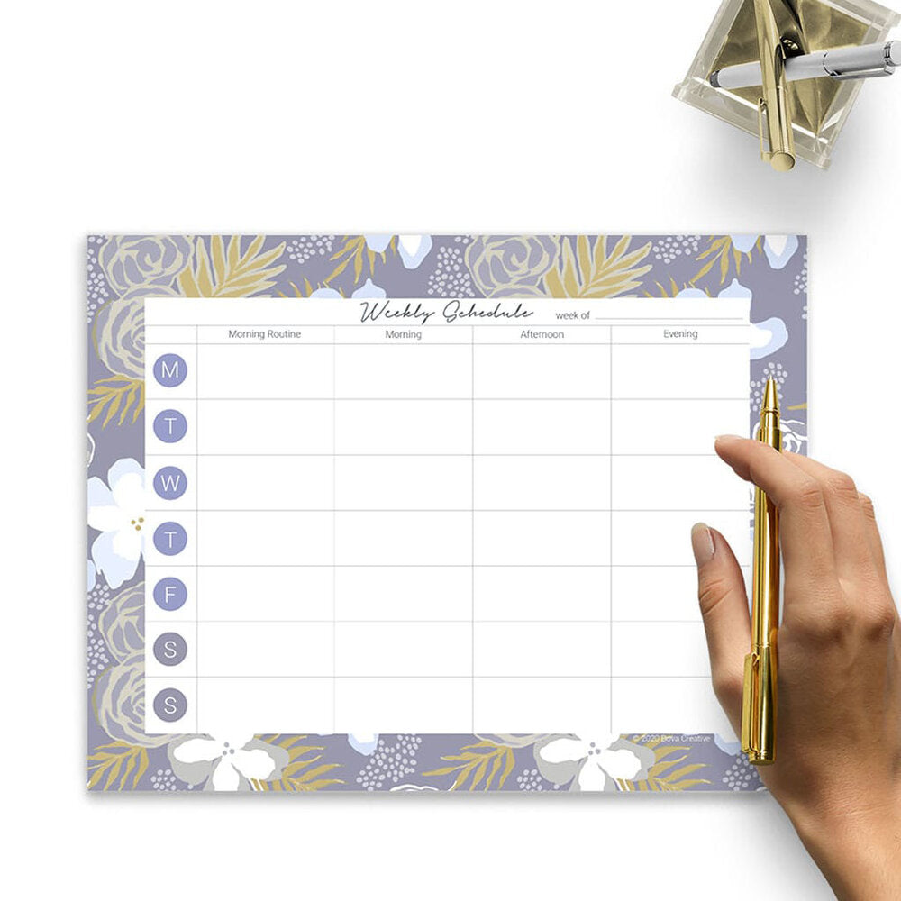 image of a woman's hand over a weekly planner page designed by Jenny Bova. The woman is holding a pen