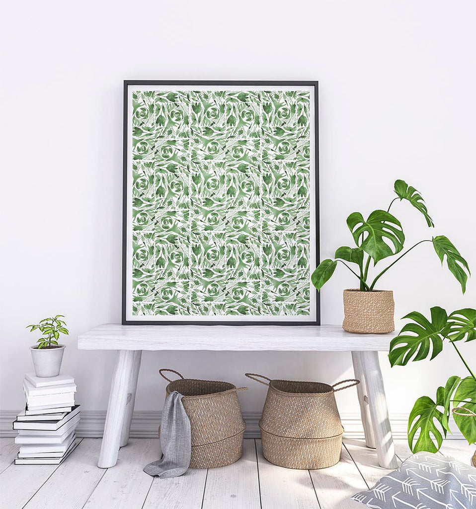 green and white art print framed on a bench with a throw and a basket
