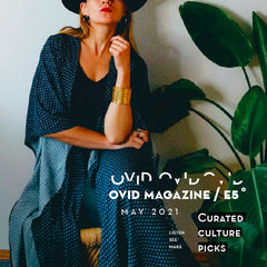 Image of a woman sitting in a blue jacket, there is a plant next to her. White text says Ovid Magazine E5 May 2021 Curated Culture Picks