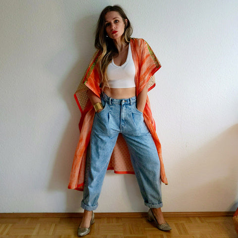 Woman in jeans and an orange jacket