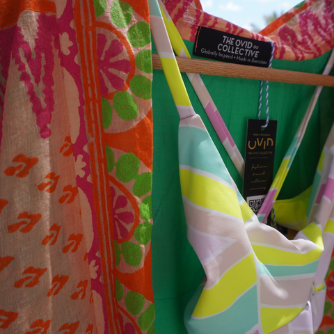 Close up of a pink and orange jacket with a neon swimsuit