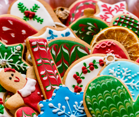 A variety of color Christmas sugar cookies decorated with festive holiday cookie designs.