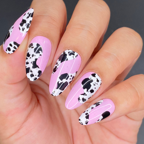 Cow print nail art with pink waves, perfect for a barbie cowgirl halloween costume