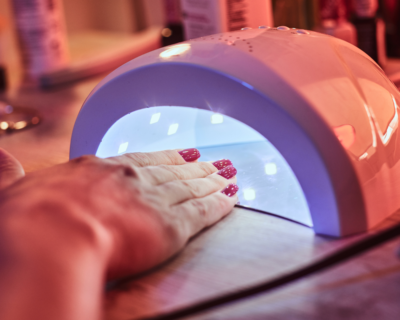 Woman getting gel manicure at a nail salon. A blog about if you stamp with a gel manicure?=