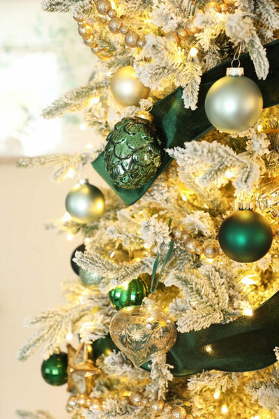 a Christmas tree with gold and emerald ornaments  cross gifts mary mary wall joy