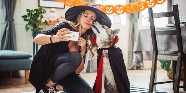 a girl and dog wear costumes for halloween haunted houses monster mash trick or treating trick or treat celebrate halloween party halloween treats holiday house house kids kids kids house family costume family