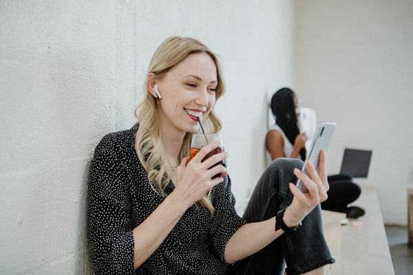girl smiling at her phone sipping a drink cool summer color palette light grey dark neutrals higher contrast coolest end all the colors summer seasons true summer