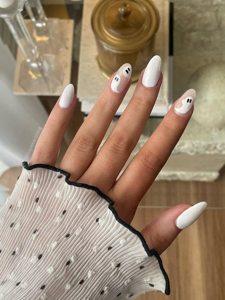 girls hand with white ghost nail design shine gel sun spring moon mani tips gel