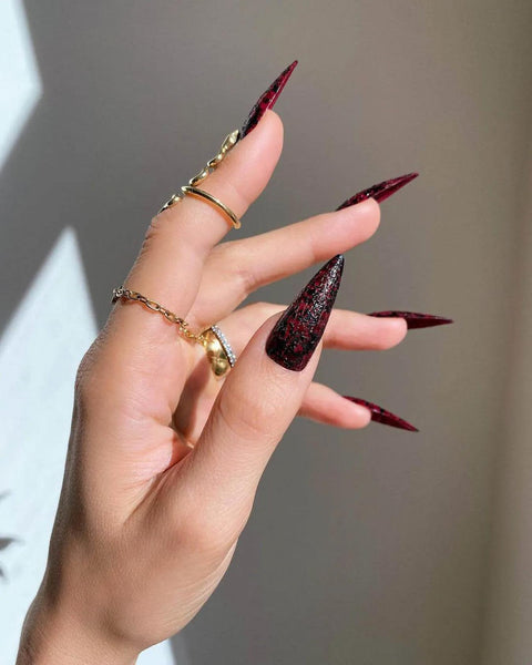 hands with rings and red and black nails goth nail designs personal style nude nails stiletto nails nail artists stiletto nails stiletto nails stiletto nails stiletto nails
