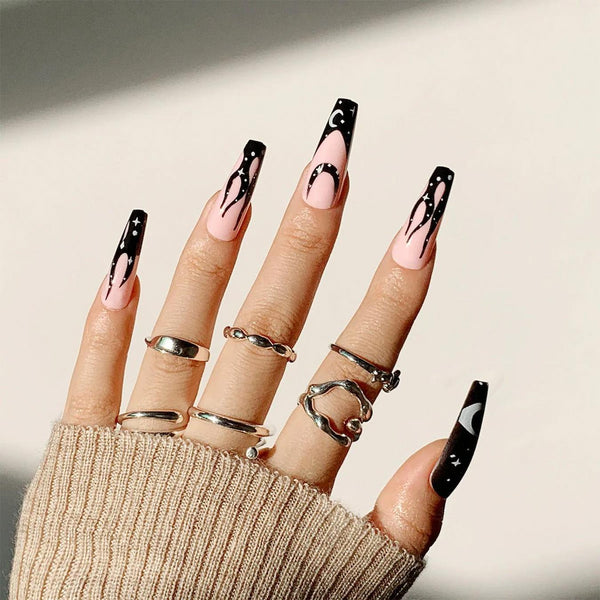 hand with lots of rings and black and nude manicure gothic nails gothic nails gothic nails nail nail gothic nails gothic nails coffin shape purple wearing purple base color nail glitter purple purple purple