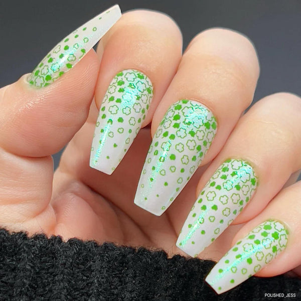 green and white nail art with four leaf clovers