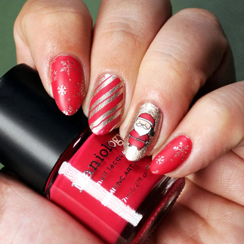 Red candy cane striped manicure with a santa claus nail design