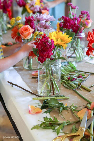 someone assembling a flower arrangement explore fun activity great hobby art supplies nature
