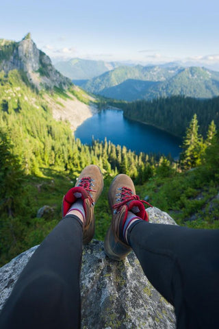 someone's feet on a high mountain top after a hike extra energy many parks take advantage