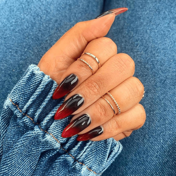 someone's hand with red and black nails special events wednesday addams fashion tips nail design matte black nails nude black acrylic nails nail design black nail designs nail design nail design black nails nail design black nails